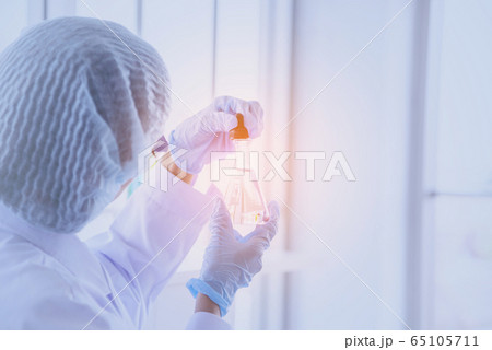 Female scientist look at microscope, science test 65105711