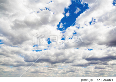 Cumulus thunderclouds on a blue sky in the atmosphere. Background for text and lettering, copy space Cumulus thunderclouds on a blue sky in the atmosphere. Background for text and lettering, copy space 65106864