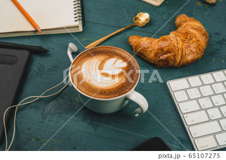 Latte coffee on the desk at home Latte coffee on the desk at home 65107275