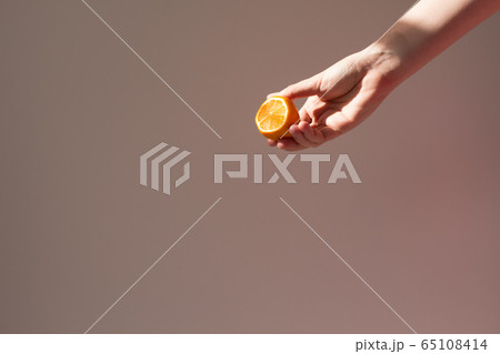 woman holds lemon blank for cosmetic home skin care, spa and natural cosmetics concept. Mockup, copy space 65108414