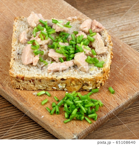 Cod liver over brown bread with spring green Cod liver over brown bread with spring green 65108640