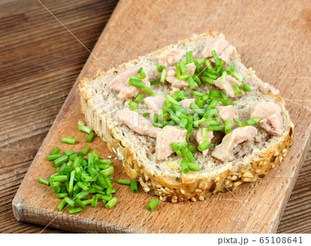 Cod liver over brown bread with spring green Cod liver over brown bread with spring green 65108641