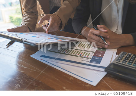 Business team brainstorming and discussing with financial data and report graph. Business team brainstorming and discussing with financial data and report graph. 65109418