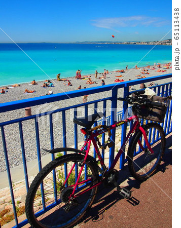 landscape of resort beach with red bicycle in Nice 65113438