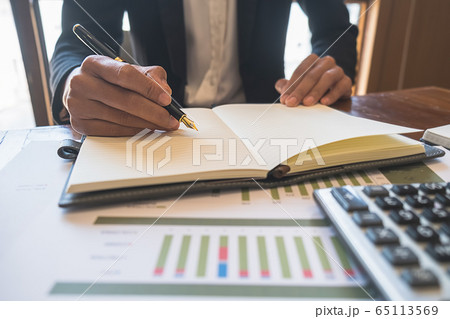 Business woman discussing the charts and graphs showing the results of their successful teamwork. Business woman discussing the charts and graphs showing the results of their successful teamwork. 65113569