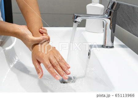 Washing hands rubbing with soap woman for corona 65113966