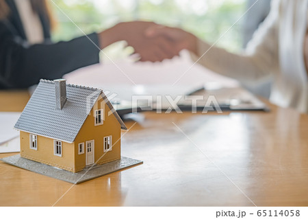 House model with agent and customer discussing for contract to buy, get insurance or loan estate. House model with agent and customer discussing for contract to buy, get insurance or loan estate. 65114058