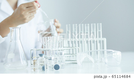 Scientist with a tube of biological sample test Scientist with a tube of biological sample test 65114684