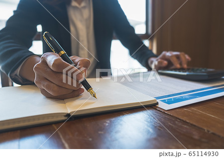 Business woman discussing the charts and graphs showing the results of their successful teamwork. 65114930