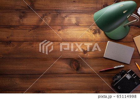 notepad or paper notebook and lamp at wooden table 65114998