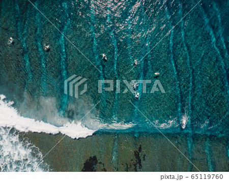 Aerial view of a lot surfers in blue ocean. Top view Aerial view of a lot surfers in blue ocean. Top view 65119760