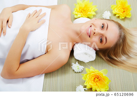 Young beautiful woman in spa environment Young beautiful woman in spa environment 65120696