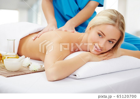 Young beautiful woman in spa environment Young beautiful woman in spa environment 65120700
