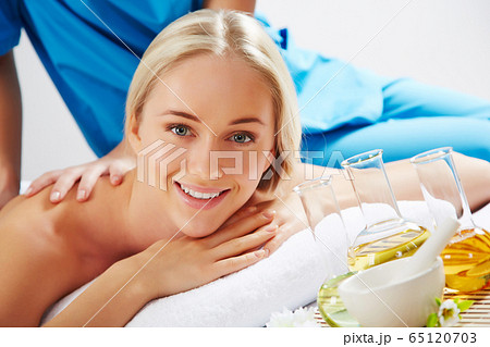 Young beautiful woman in spa environment 65120703