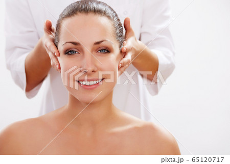 Young beautiful woman in spa environment 65120717