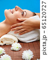 Young beautiful woman in spa environment 65120727