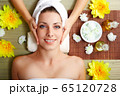 Young beautiful woman in spa environment 65120728