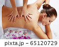 Young beautiful woman in spa environment 65120729