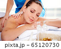 Young beautiful woman in spa environment 65120730