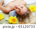 Young beautiful woman in spa environment 65120733