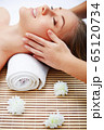 Young beautiful woman in spa environment 65120734