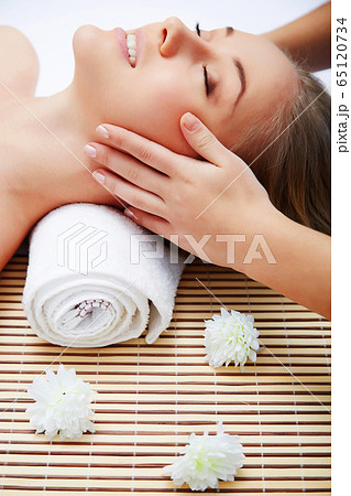 Young beautiful woman in spa environment 65120734
