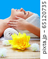 Young beautiful woman in spa environment 65120735