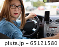 A woman driving the car backwards 65121580