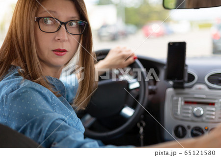 A woman driving the car backwards 65121580