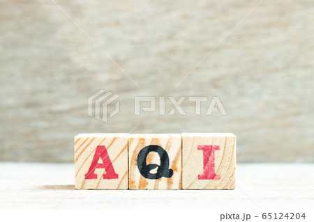 Alphabet letter in word AQI (Abbreviation of air quality index) on wood background 65124204