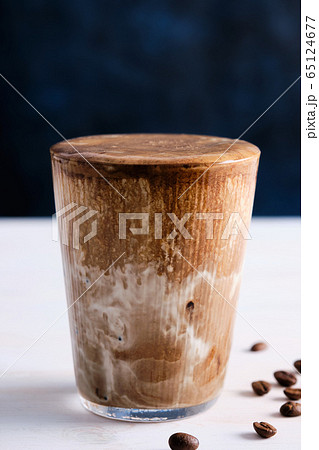 Ice coffee with milk on the white wooden table. Copy space. Ice coffee with milk on the white wooden table. Copy space. 65124677