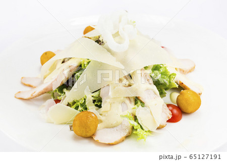 Warm salad of vegetables and meat. Close-up shot on a table in a restaurant. Warm salad of vegetables and meat. Close-up shot on a table in a restaurant. 65127191