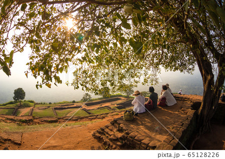 Group of unrecognizable tourists enjoying amazing view from mount Sigiriya, Sri Lanka, Ceylon. Sigiriya, Lion rock, is a large stone and ancient palace ruin in the central Sri Lanka 65128226