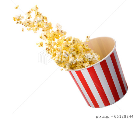 Flying popcorn from paper striped bucket isolated on black background 65128244