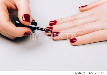 Woman making self manicure 65129043