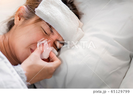 Sick asian woman have high fever flu and illness Sick asian woman have high fever flu and illness 65129799