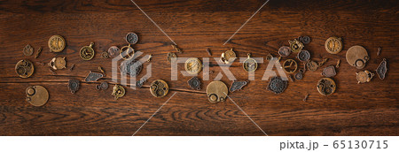 Mechanical cogwheel elements on a dark wooden Mechanical cogwheel elements on a dark wooden 65130715