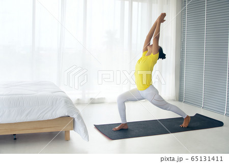 Skinny woman wear yellow sport t-shirt practice yoga 65131411