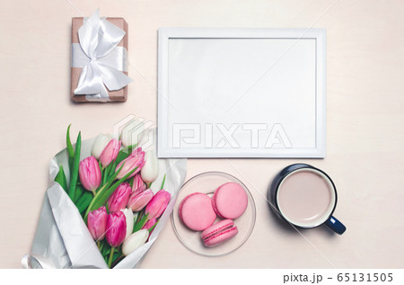 Coffee cup, tulip flowers and pink macarons on 65131505