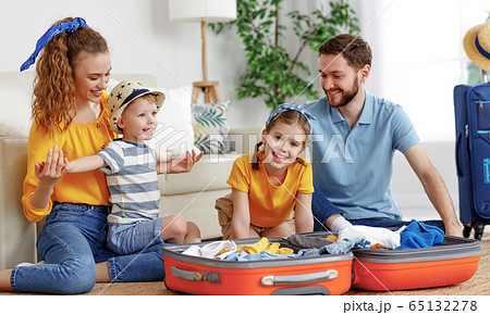 Cheerful family with suitcases on floor 65132278