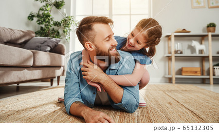 Cheerful father and daughter having fun and 65132305