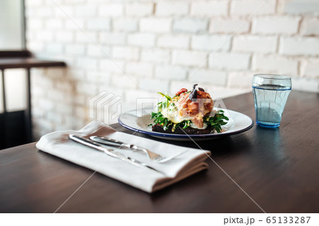 Rye toast with poached egg and salmon Rye toast with poached egg and salmon 65133287