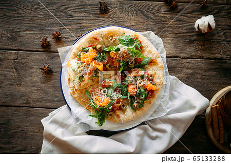 Italian pizza with salmon olives and arugul Italian pizza with salmon olives and arugul 65133288