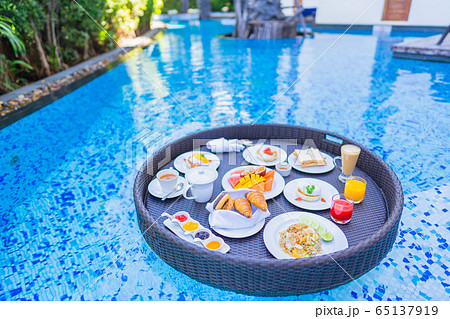 Floating breakfast set in tray with fried egg omelette sausage ham bread fruit milk juice coffee Floating breakfast set in tray with fried egg omelette sausage ham bread fruit milk juice coffee 65137919