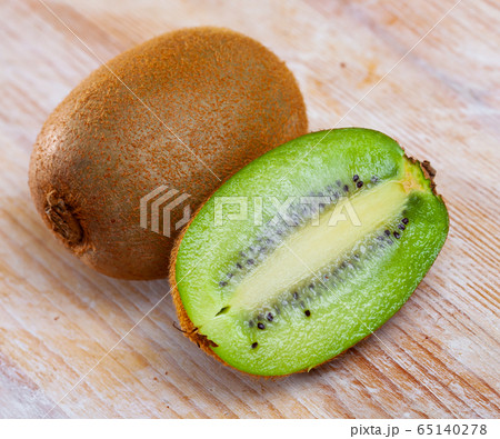 Ripe kiwi on wooden table 65140278