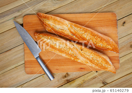 Fresh bread on a wooden cutting board Fresh bread on a wooden cutting board 65140279