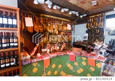 Assortment of traditional Spanish meat shop with dangling legs jamon Assortment of traditional Spanish meat shop with dangling legs jamon 65140414