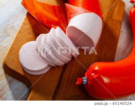 Appetizing boiled sausage mortadella on wooden table Appetizing boiled sausage mortadella on wooden table 65140524