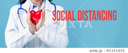 Social Distancing theme with a doctor holding a heart Social Distancing theme with a doctor holding a heart 65141035