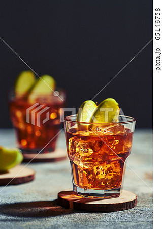 Apple juice whiskey cocktail under hard sunlight 65146758